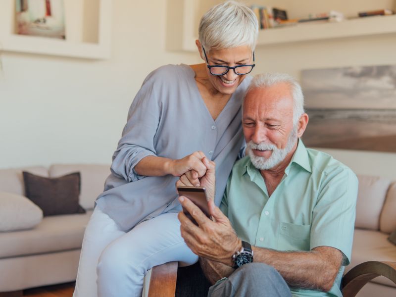 an old couple using personal banking services on mobile